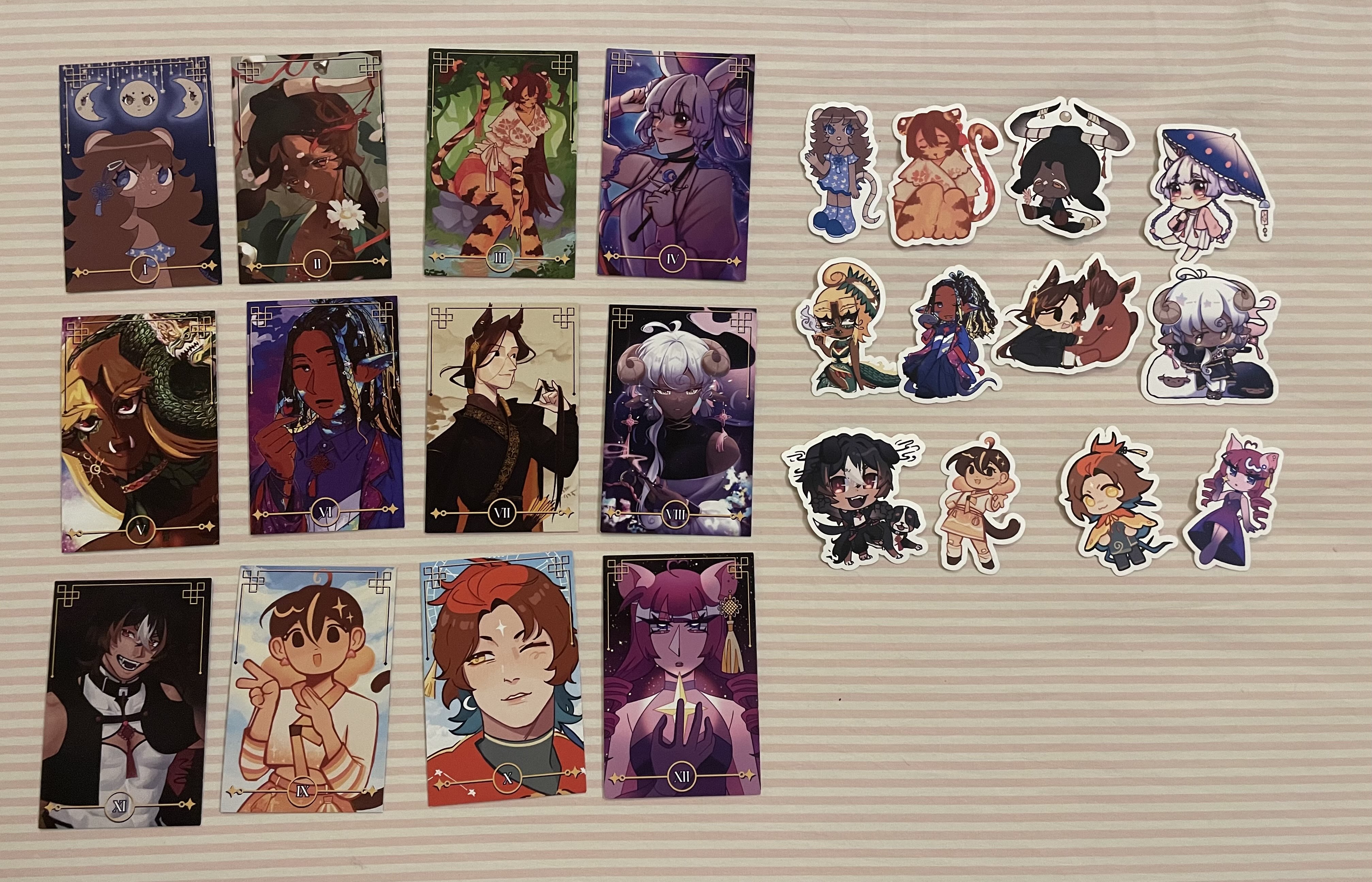 A photo of twelve photocards and stickers of Chinese zodiac gijinka.