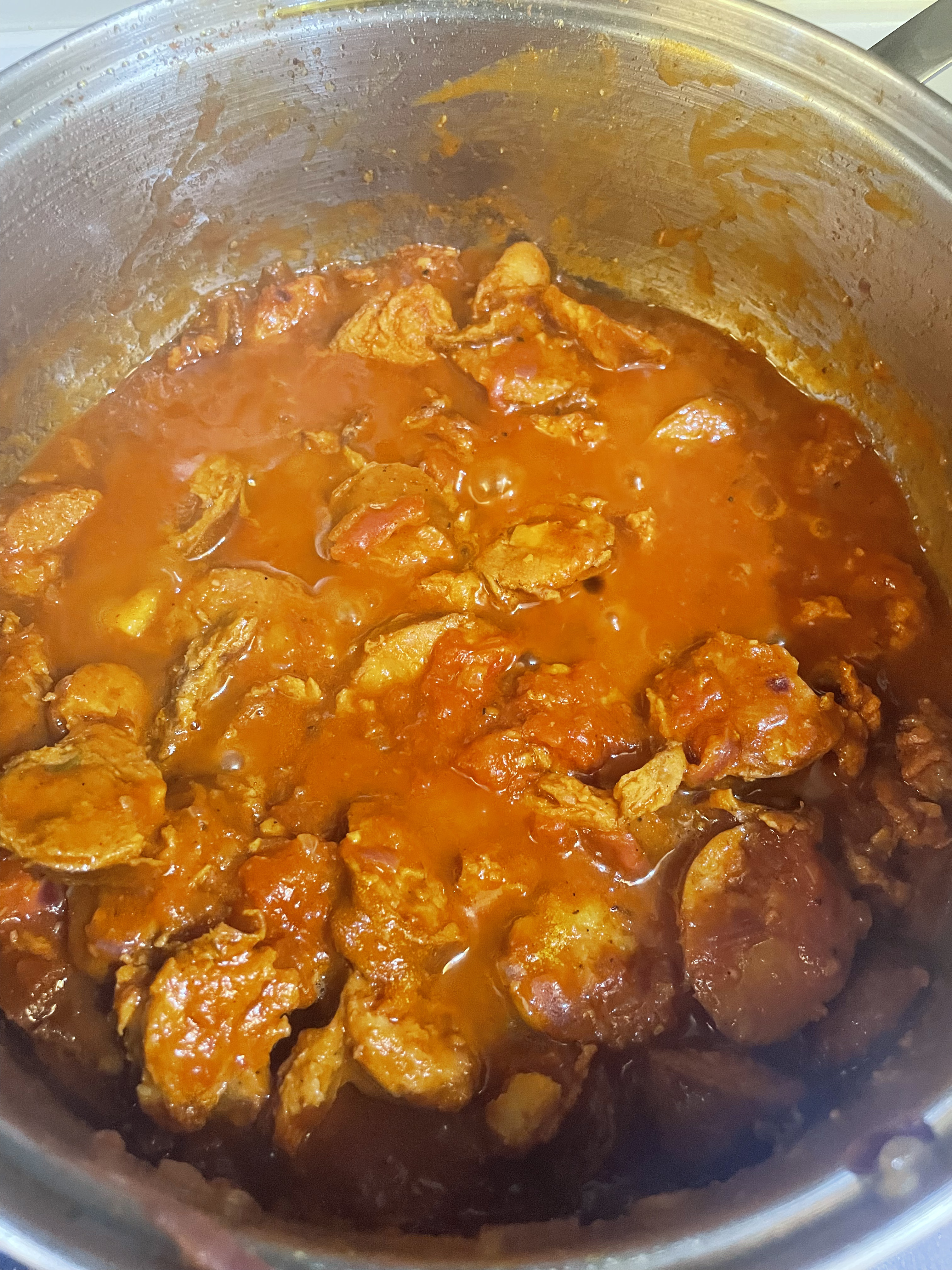 reunionese sausage rougail, still simmering in a pot.